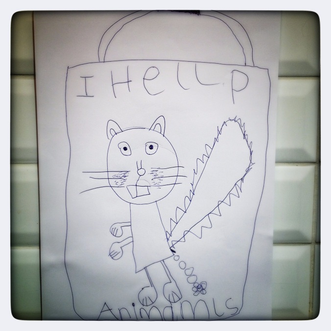 Child's drawing of a squirrel with the words 'I help animals'